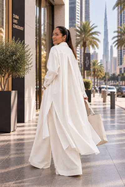 A long shirt made in organic cotton that is true to our minimalistic design and lightweight for a day at the beach or dress it up with a belt. Dubai. Sustainable Fashion.