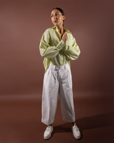 Full-length styling of Isla organic cotton shirt with white trousers