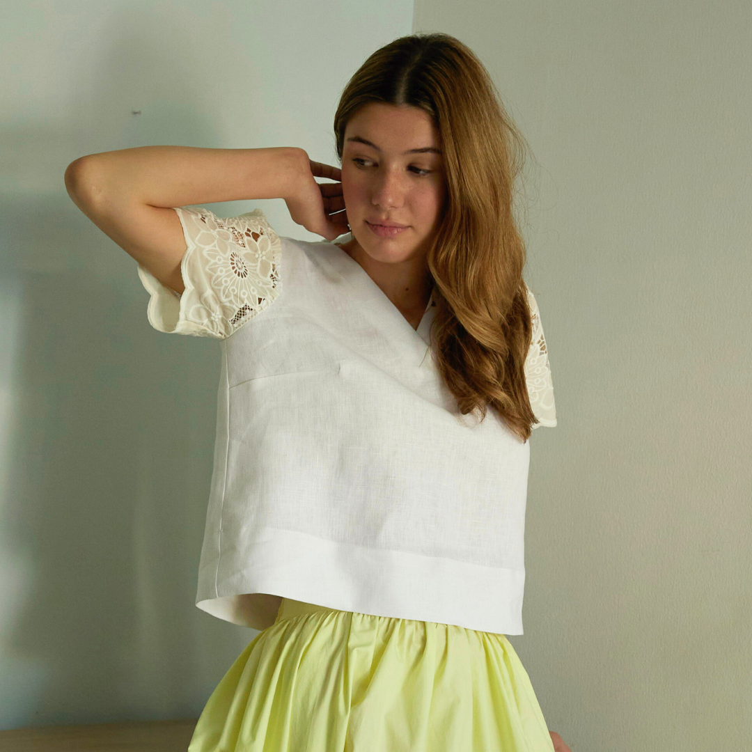 White top with lace details and a yellow skirt. Sustainable fashion