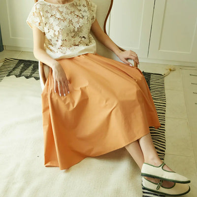 Safina burnt orange pleated midi skirt in GOTS-certified organic cotton poplin, made in the UAE
