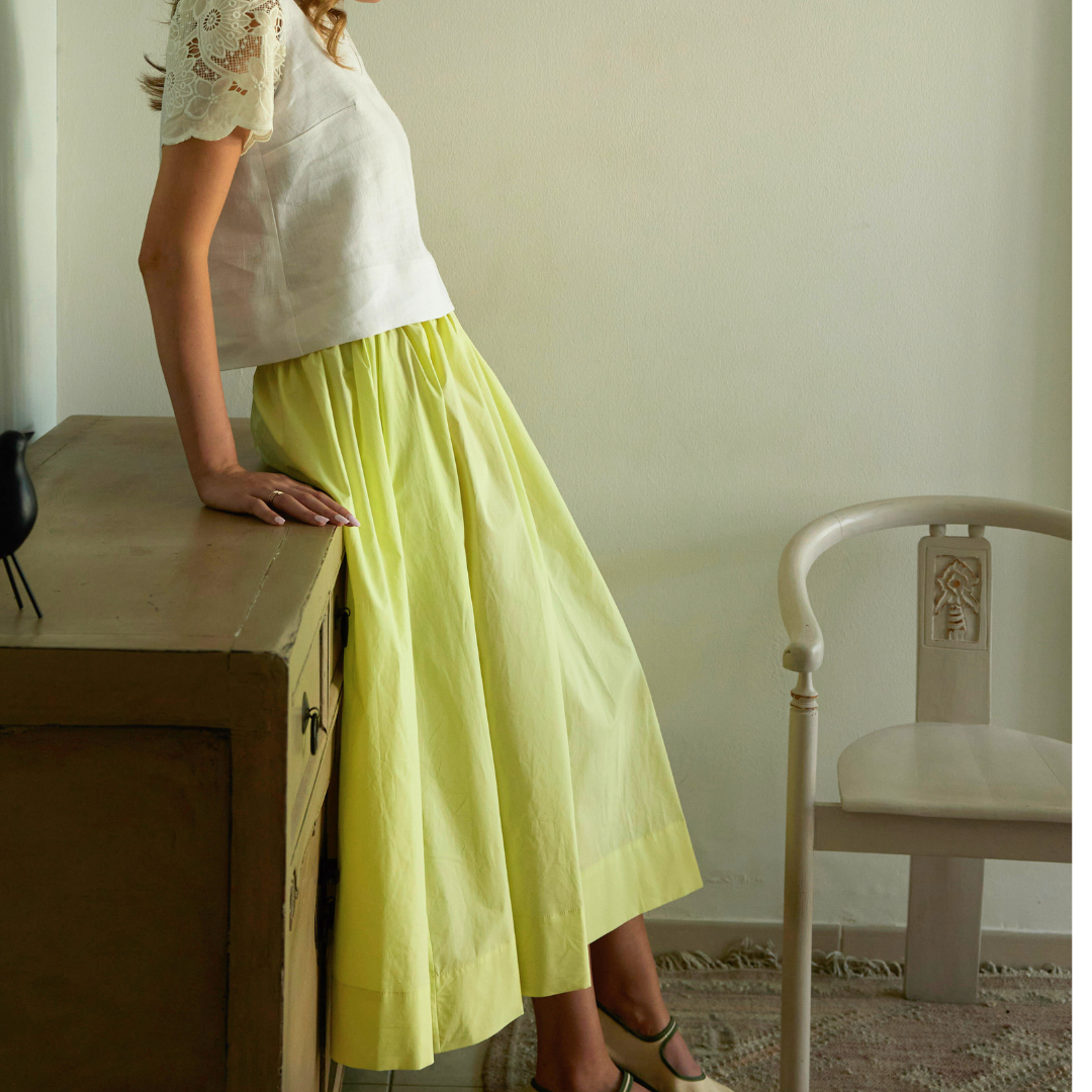 Shama lemon yellow organic cotton midi skirt, full-length side view