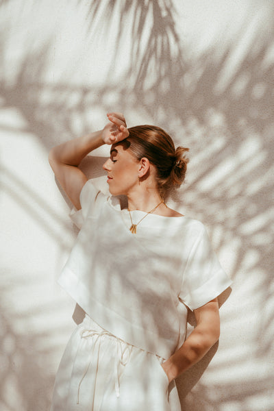 Woman wearing Ume off-white Italian linen crop top and shorts set