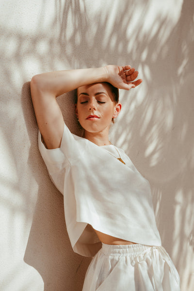 Woman wearing Ume orange Italian linen crop top and shorts set
