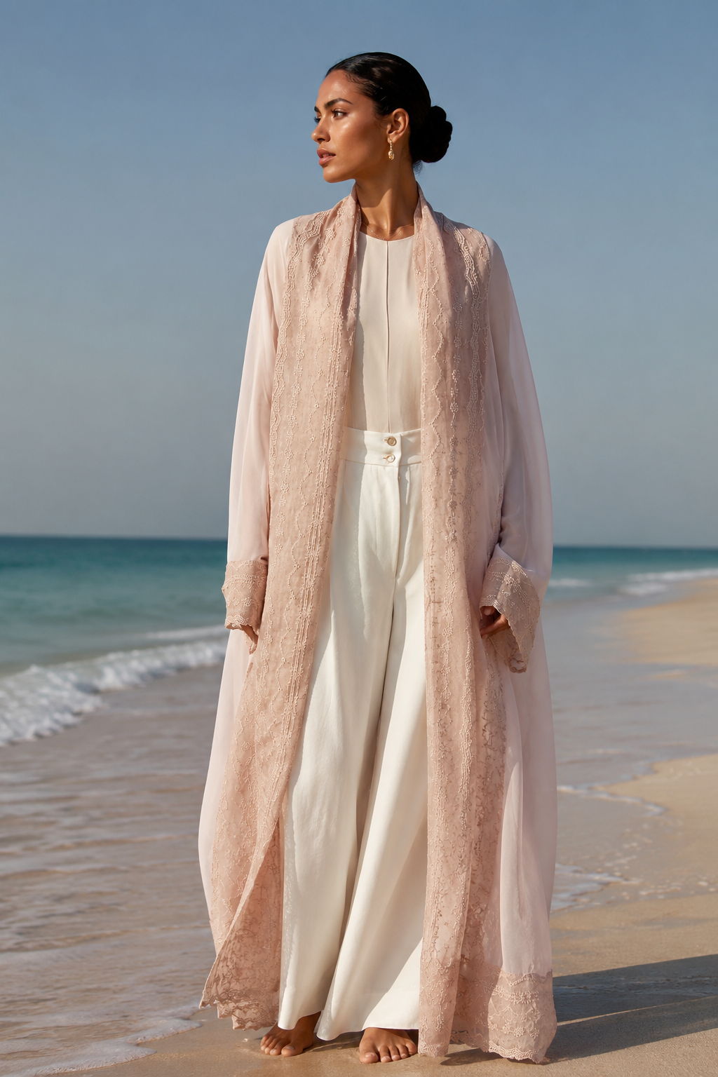 An oversized, floor-length shawl abaya crafted from premium Italian linen, featuring soft pastel hues and delicate thread work trim along the neckline, sleeves, and hem.