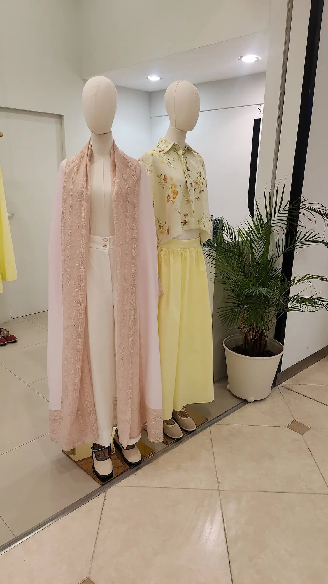 An oversized, floor-length shawl abaya crafted from premium Italian linen, featuring soft pastel hues and delicate thread work trim along the neckline, sleeves, and hem.